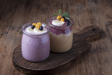  Smoothies with cloudberries, a banana and a blueberry