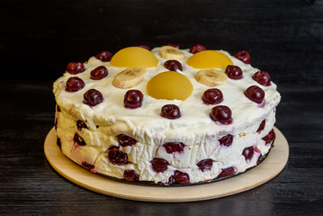 jelly cake with cherries on a wooden background.