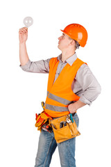 portrait of a male builder in a helmet over white wall background. repair, construction, building, people and maintenance concept.