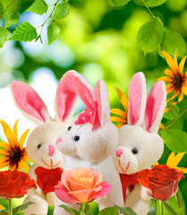  toy hares and flowers in the garden