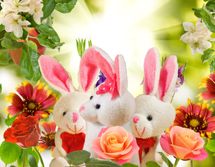 image of toy hares and flowers in the garden