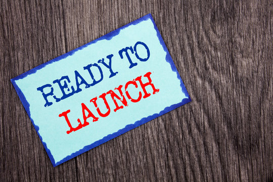 Writing text showing  Ready To Launch. Business photo showcasing Prepare New Product Promotion Start Release written on Blue Sticky Note Paper on the wooden background.