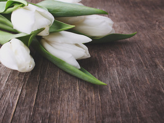 Easter concept - flowers(white tulips) on rustic wood background