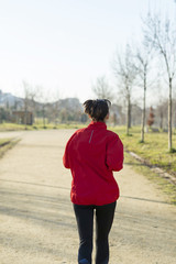 Obraz premium Active and sporty woman runner in autumn nature