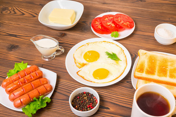 morning breakfast with setting food products over wooden background, flat lay