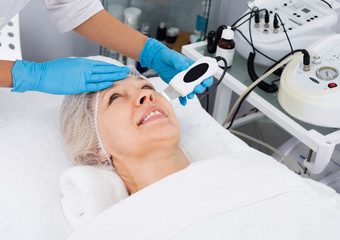 Mature woman having beauty procedures