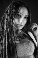 Young woman with dreadlocks and tattoo