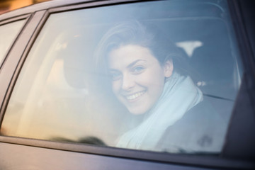 Fototapeta na wymiar Smiling girl travelling by car