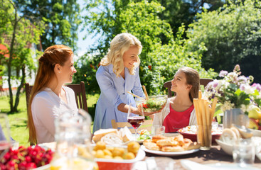leisure, holidays and people concept - happy family having festive dinner or summer garden party