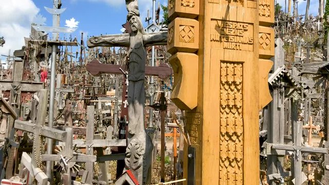 SIAULIAI, LITHUANIA - JULY 2017: Tourists visit Hill of Crosses. It is a major attraction in Lithuania