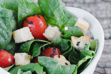 Vegetable salad on rustic wooden background.
