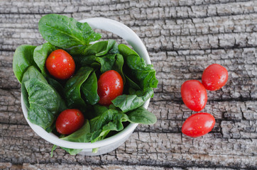 Vegetable salad on rustic wooden background.