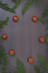Wooden food background with fresh tomatoes and parsley. Tomatoes and parsley on a brown wooden background.