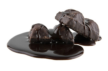 chocolate candies in liquid chocolate isolated on white background