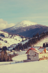 Mountain house covered with fresh snow in the Carpathian mountains