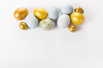 Easter background with Easter eggs and spring flowers. Top view with copy space