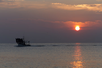 Fototapeta premium fishing boat coming back