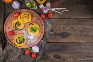 Cherry tomatoes, uncooked spaghetti, red onion and herbs