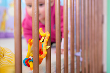Fototapeta na wymiar Baby playing in a crib.