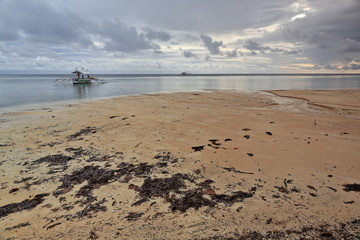 Balangay or bangka boats sailing along the beach. Punta Ballo-Sipalay-Philippines. 03340