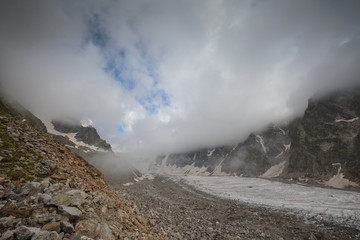 Movement of clouds and water flows in a stormy river in the Caucasus mountains in summer