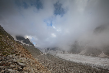 Movement of clouds and water flows in a stormy river in the Caucasus mountains in summer