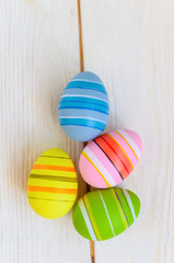 Beautiful bright postcard (background) for a light holiday of Easter - four multicolored easter painted eggs