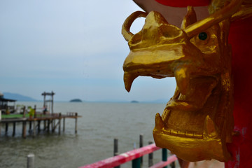 Golden dragon statue in Koh Lanta, Thailand. Chinese temple.