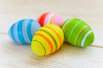 Beautiful bright postcard (background) for a light holiday of Easter - four multicolored easter painted eggs