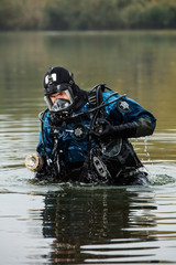 brave diver rescuer comes out of the water