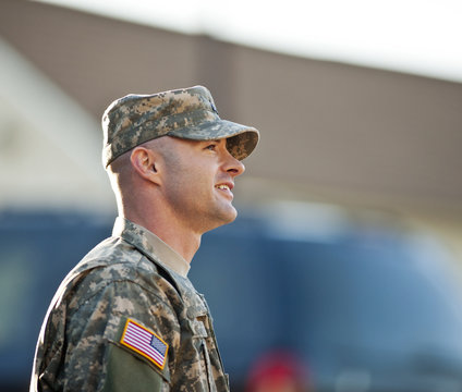 Smiling male army soldier in uniform.