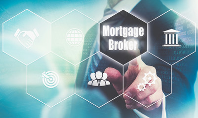 Businessman pressing a Mortgage Broker business concept button.