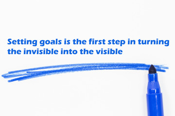 Setting goals is the first step in turning the invisible into the visible  word written with blue...