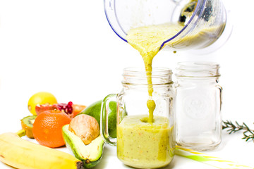 Woman pouring avocado smoothie from a blender