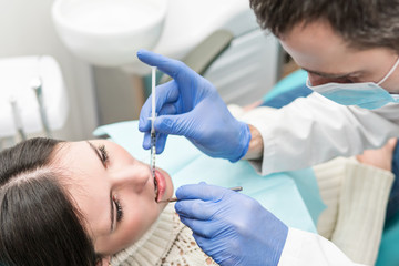 Dentist makes an anesthetic injection for the patient
