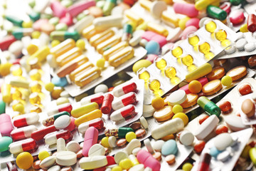 Pills close up and colorful blister packs
