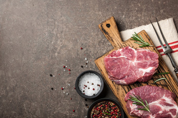 Raw pork steaks with rosemary and spices