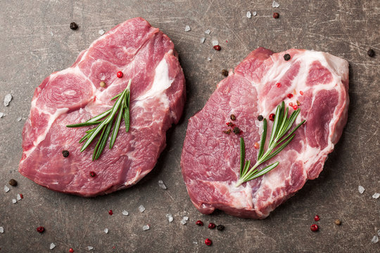 Raw pork steaks with rosemary and spices