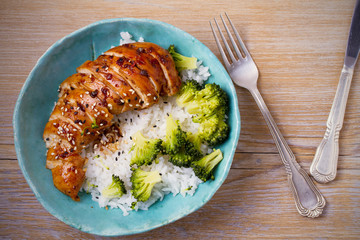 Glased chicken breast, rice and broccoli as garnish. Chicken in balsamic vinegar and brown sugar sauce