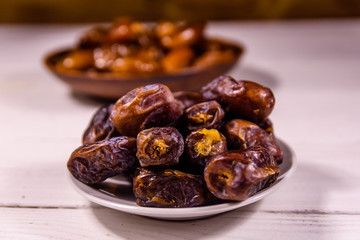 Date fruits on the white wooden table