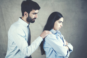  sad man  and angry woman in dark background