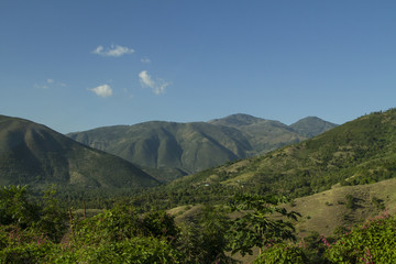 Fototapeta premium Haitian mountains and green valley at 'Grand Anse' region. Blue sky with clouds. / Haiti