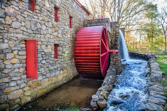 old grist mill. working water mill with a red wheel. Old stone grist mill in Sudbury, MA