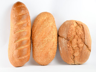 Loaves of bread isolated on white background. Wheat, rye, bread with sesame seeds..