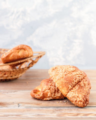 Fresh Croissants on rustic wooden background. Selective focus, horizontal.