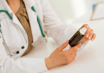 Fototapeta na wymiar Closeup on medical doctor woman holding medicine bottle