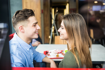 Happy couple at restaurant eating lunch