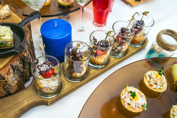 Beautiful catering banquet table with different food snacks and appetizers decorated for celebration party, closeup.