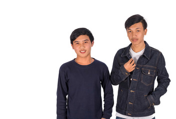 Two Asian boys are pointing to the camera.