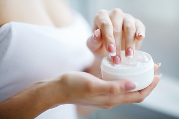 Hand Skin Care. Close Up Of Female Hands Holding Cream Tube, Beautiful Woman Hands With Natural Manicure Nails Applying Cosmetic Hand Cream On Soft Silky Healthy Skin.